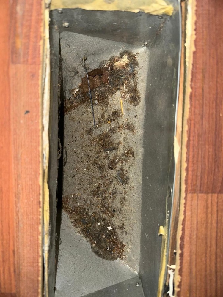 Technician cleaning a home air duct system