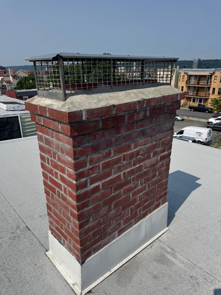 Rebuilt brick chimney with new cap