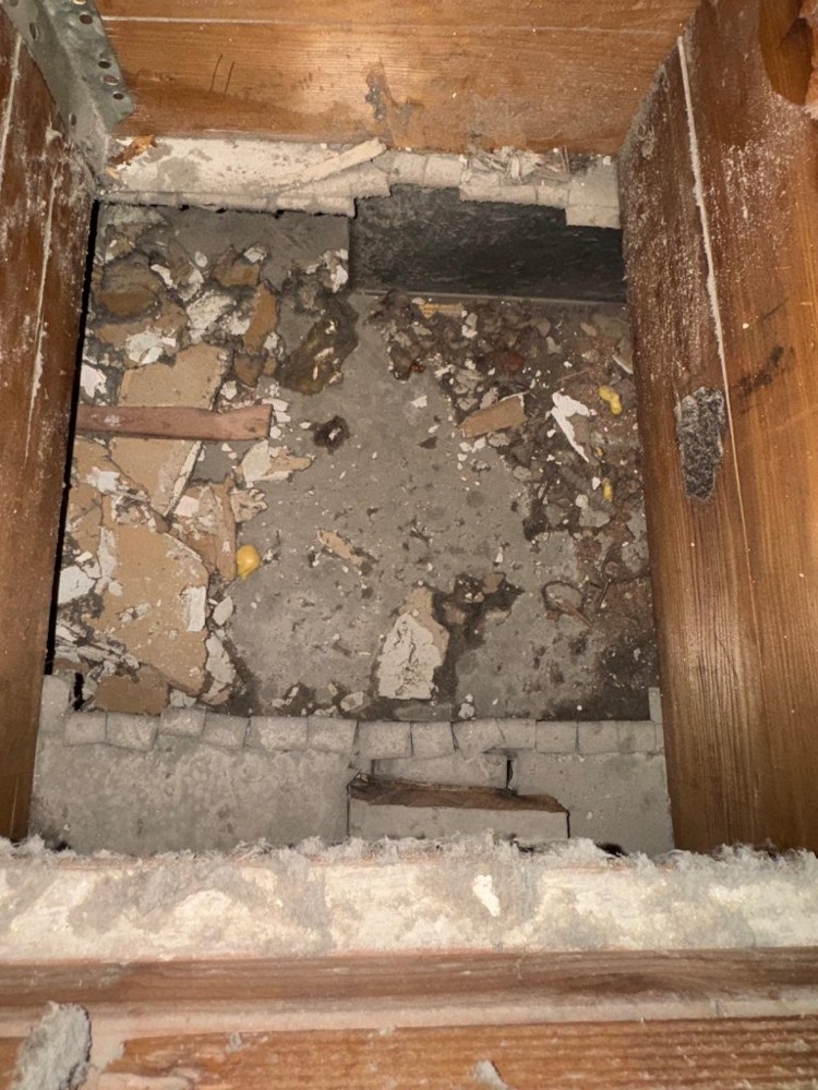 Air duct filled with construction debris before cleaning